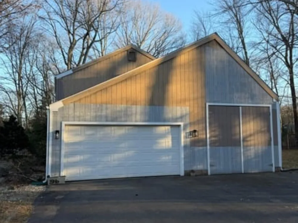 Structural carpentry repair on exterior garage façade