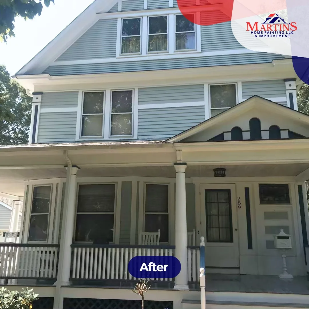 After exterior house painting: fresh light blue siding and crisp white trim.